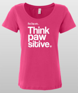 Pink T-shirt with "Think Pawsitive" dog-themed text design.