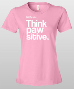 Pink t-shirt with "Think Pawsitive" dog-themed slogan in white text.