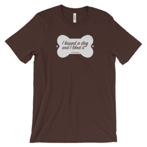 Brown shirt with "I kissed a dog and I liked it" text in bone-shaped design.