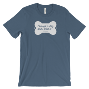 Blue T-shirt with "I kissed a dog and I liked it" inside a white bone design.