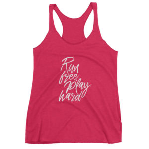 Pink tank top with "Run free, play hard" in stylish white script.